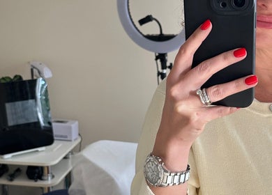 Woman with red nails taking a selfie at The Skinbar, Атлон, Уэстмит, IE, reflecting salon ambience.