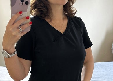 Woman takes a mirror selfie at The Skinbar, Атлон, Уэстмит, IE, showcasing beauty salon ambiance.