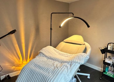 Luxury treatment room at Glow Beauty by Sian, Solihull, England, GB with spa bed and ambient lighting.