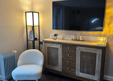 Elegant corner with TV, lamp, and soft chair at Glow Beauty by Sian, Solihull, England, GB.