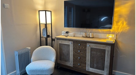 Elegant corner with TV, lamp, and soft chair at Glow Beauty by Sian, Solihull, England, GB.