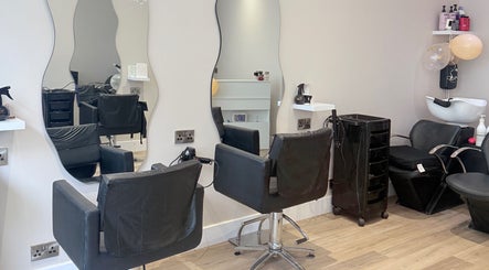 Chic salon interior at Dream Hair, Huntingdon, England, GB with modern styling stations and mirrors.