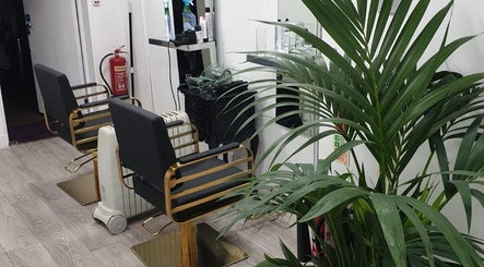 Luxurious salon chairs at Ray's House of Beauty Kingston, Kingston Upon Thames, England, GB with vibrant plant.