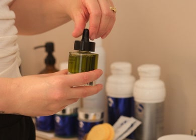 Aesthetician holding serum bottle at Alma Aesthetics, Brighton And Hove, England, GB.