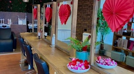 Elegant salon interior at Naughtycornerhairco, Saint Leonards, England, GB, with decorative red accents.