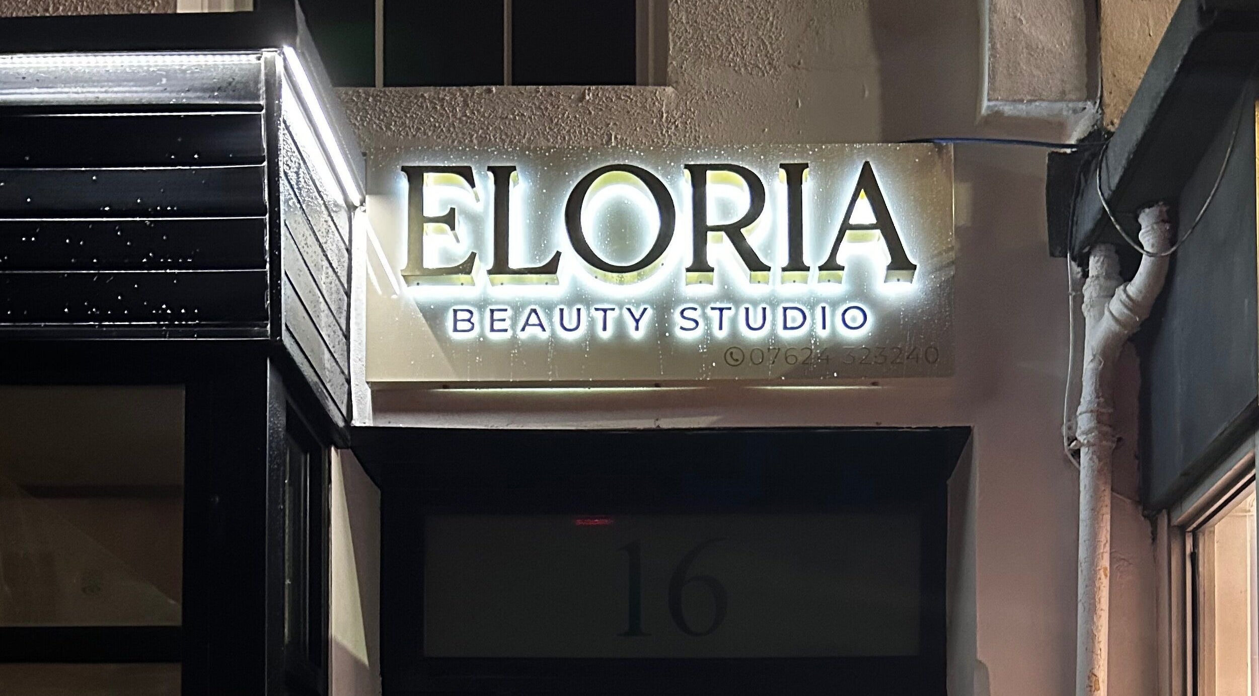 Illuminated sign of Eloria Beauty Studio in Douglas, IM, featuring elegant branding at night.