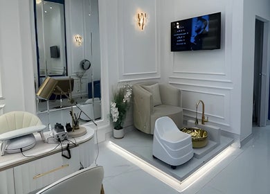 Lumiere Ladies Salon in Dubai, AE features chic beige seating with modern decor and gold accents.