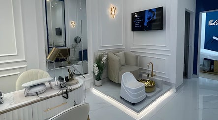 Lumiere Ladies Salon in Dubai, AE features chic beige seating with modern decor and gold accents.