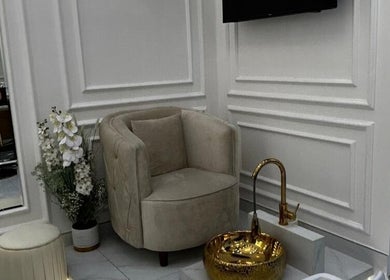 Elegant pedicure chair and foot basin at Lumiere Ladies Salon, Dubai, AE. Chic relaxation and spa experience.