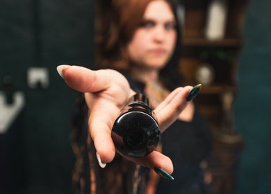 Close-up of a woman's hand offering a makeup product at Enchantress, Shelbyville, Tennessee, US.