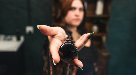 Close-up of a woman's hand offering a makeup product at Enchantress, Shelbyville, Tennessee, US.