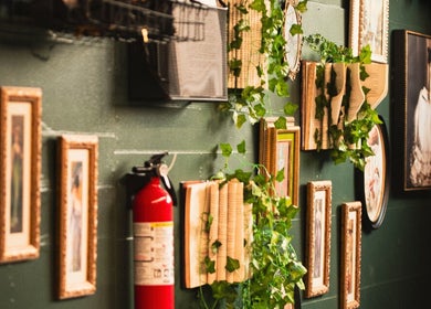 Enchanting wall decor at Enchantress, Shelbyville, Tennessee, US featuring books and framed art.
