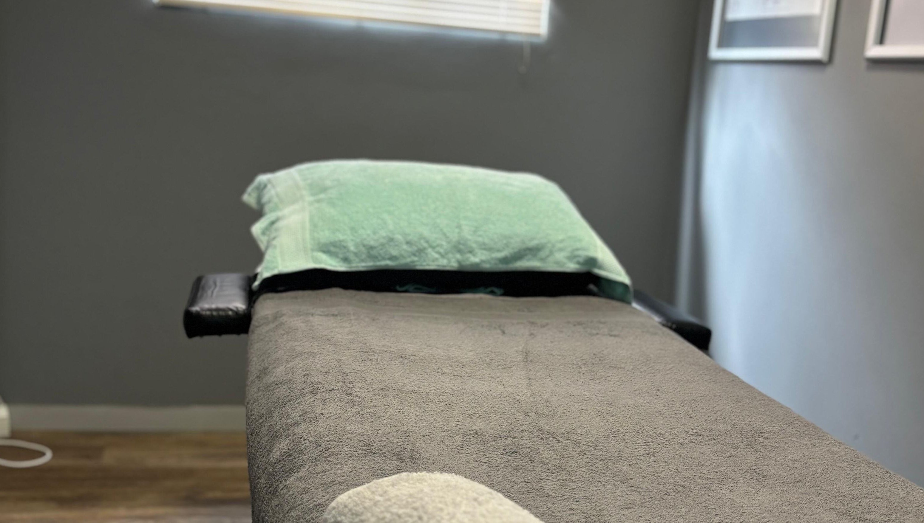 Massage bed at Once Active Gym in Sandton, Gauteng, ZA, offers a serene setting for relaxation.