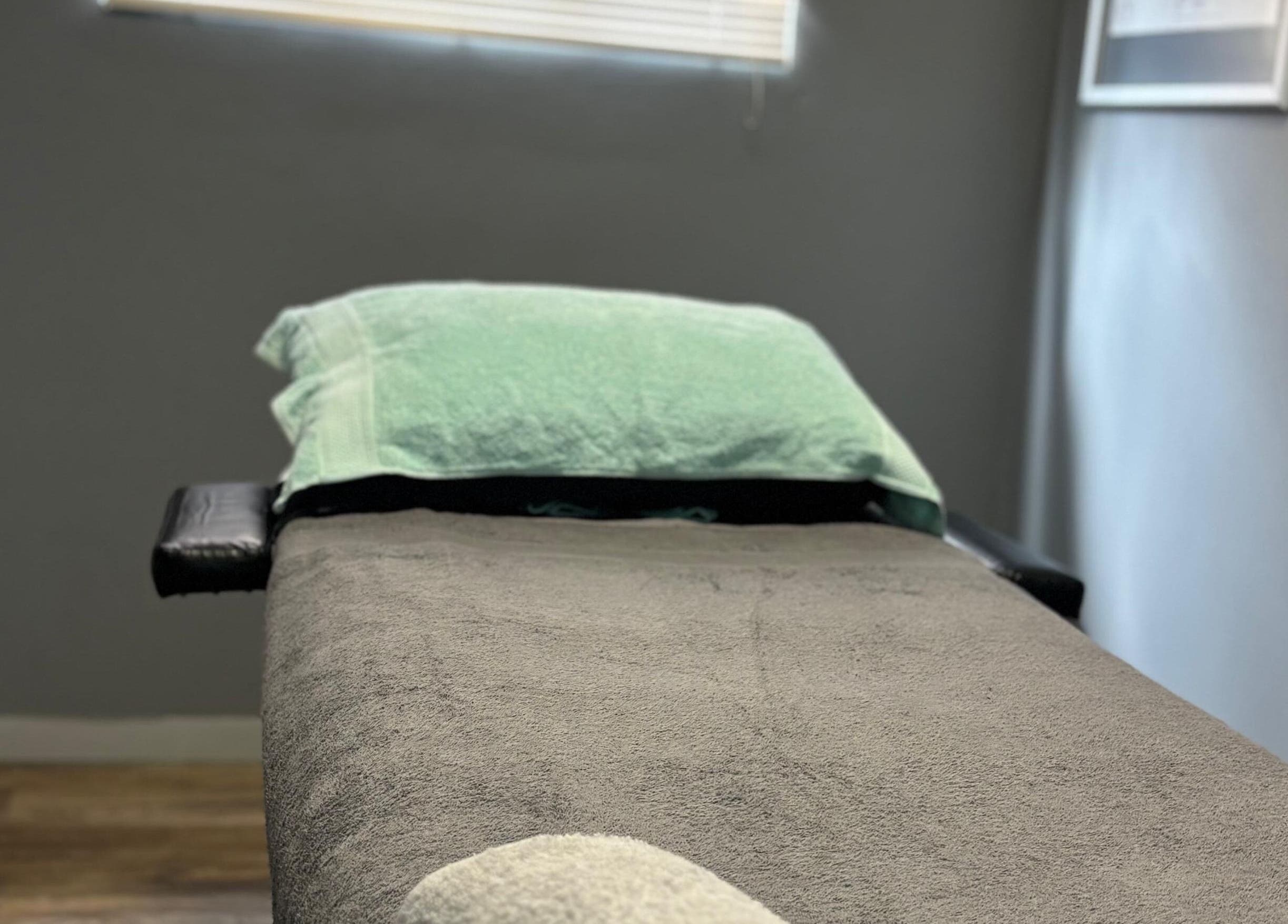 Massage bed at Once Active Gym in Sandton, Gauteng, ZA, offers a serene setting for relaxation.