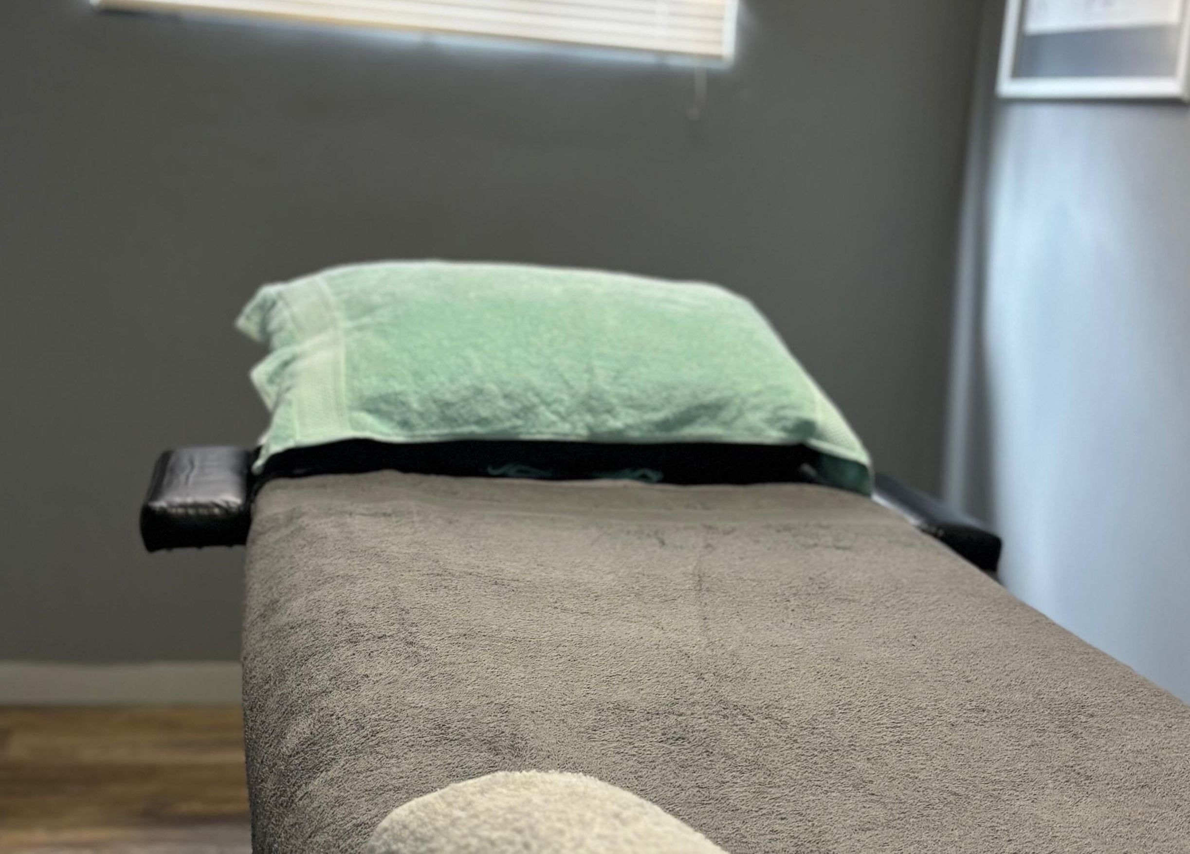 Massage bed at Once Active Gym in Sandton, Gauteng, ZA, offers a serene setting for relaxation.