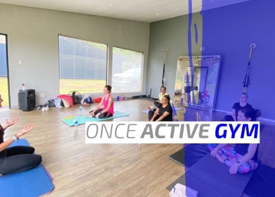 Yoga class at Once Active Gym, Sandton, Gauteng, ZA with people seated on mats in a serene studio.