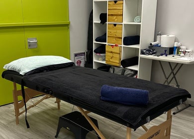 Massage room at Wanderers Sports Medical Centre, Johannesburg, Gauteng, ZA with a green accent wall and treatment table.