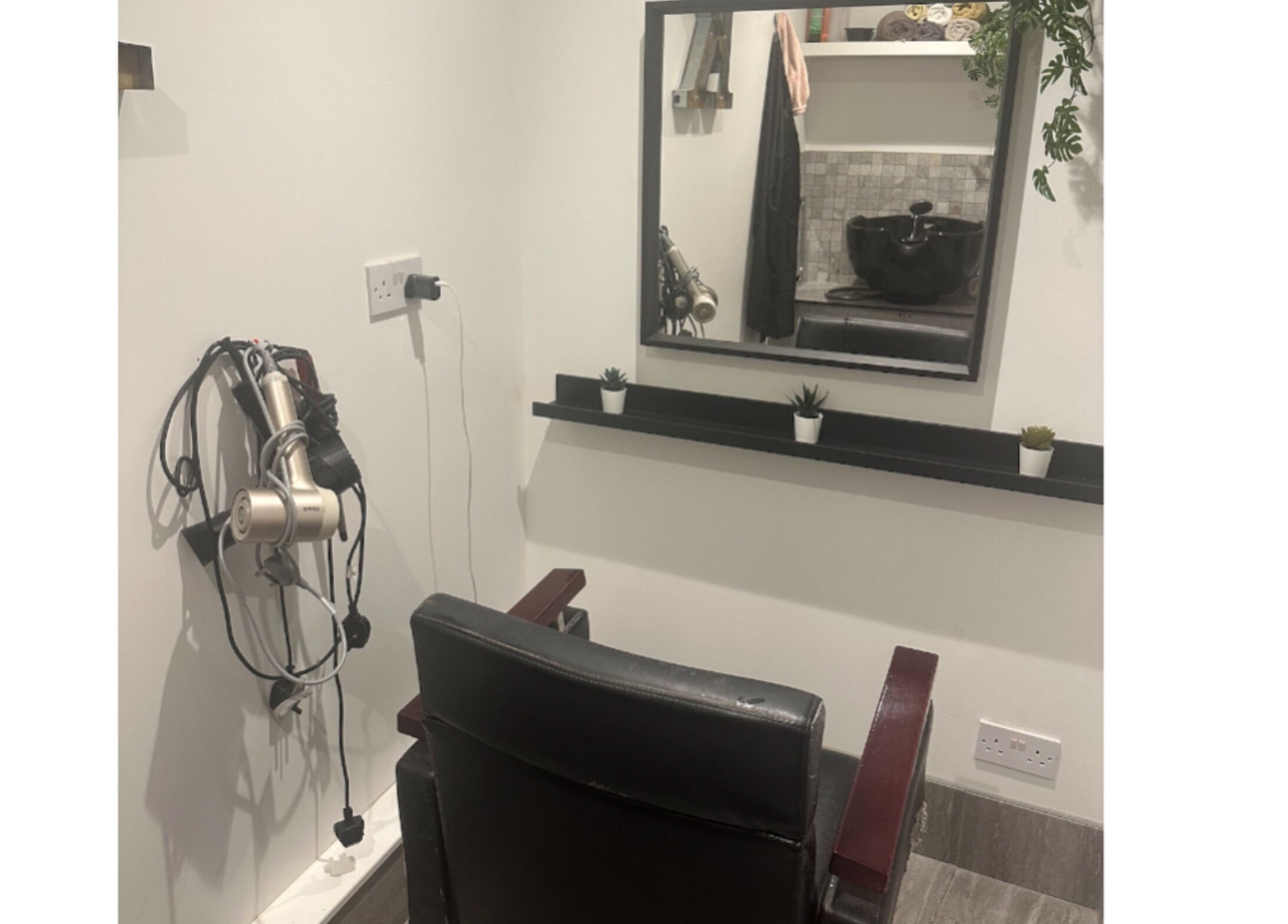Chic styling station at Hair.by.kitty, Bletchley, England, GB, featuring mirror, chair, and styling tools.
