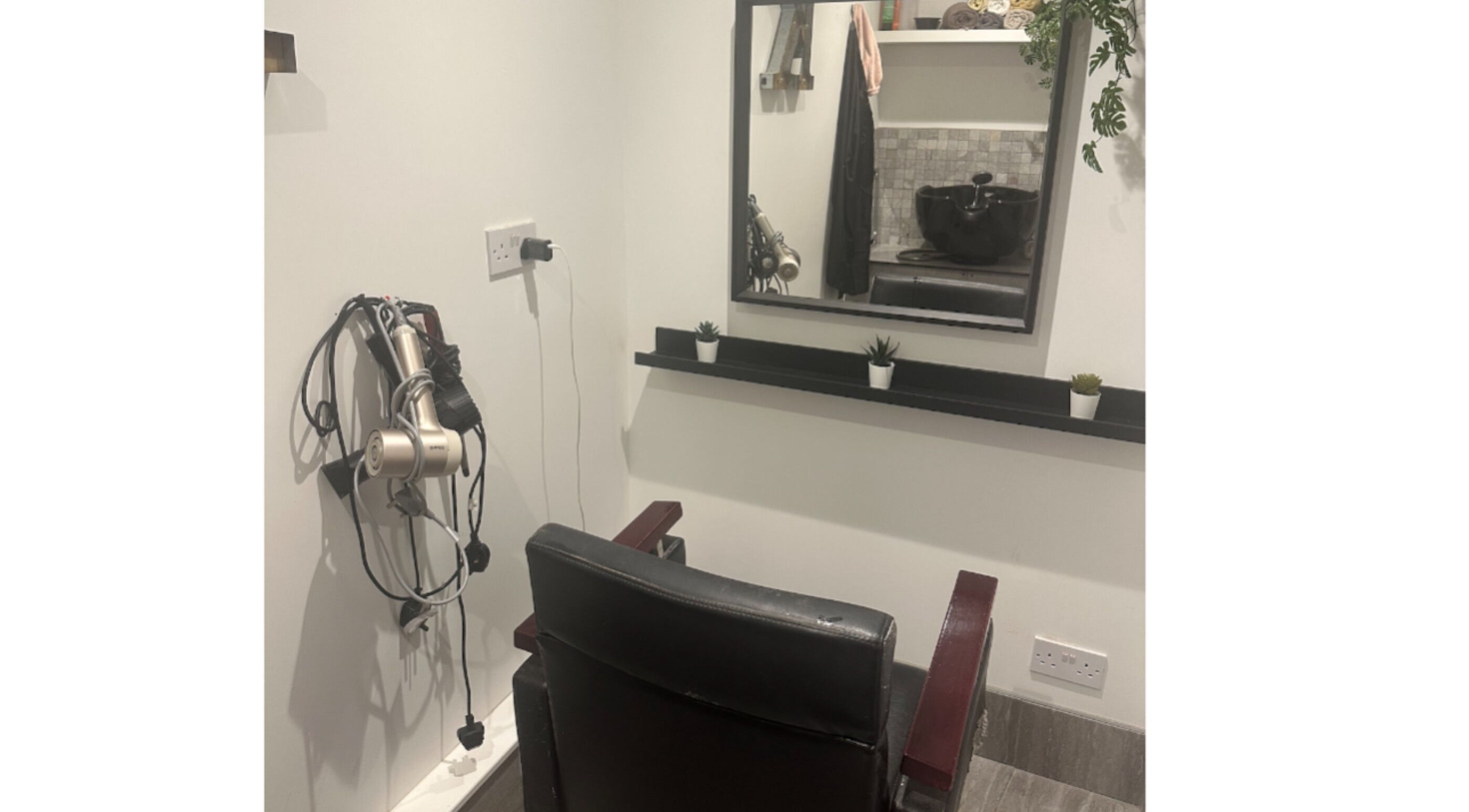 Chic styling station at Hair.by.kitty, Bletchley, England, GB, featuring mirror, chair, and styling tools.