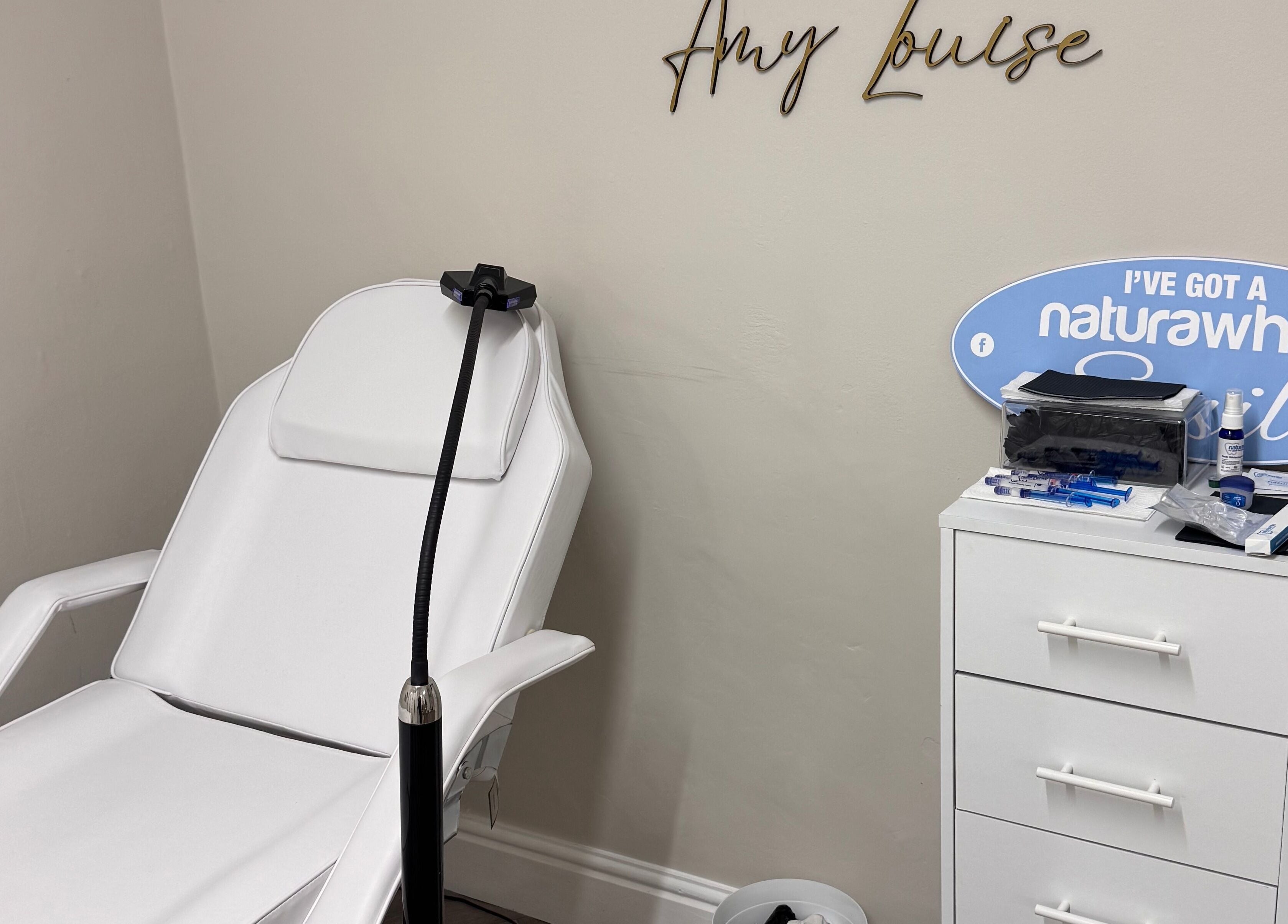 B-Radiant's serene whitening room featuring a white chair and accessories in Briton Ferry, Wales, GB.