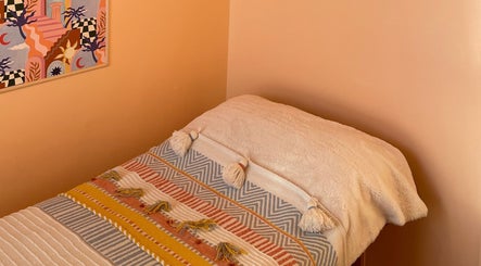 Comfortable massage bed at Sole Therapy Wirral, Wallasey, England, GB with vibrant decor.