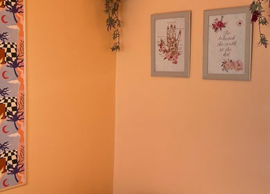 Artistic wall at Sole Therapy Wirral in Wallasey, England, GB, showcasing vibrant patterns and framed quotes.