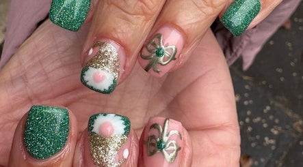 Stylish green glitter nails at Anna Rae Beauty in Paisley, Scotland, GB, showcasing festive designs.