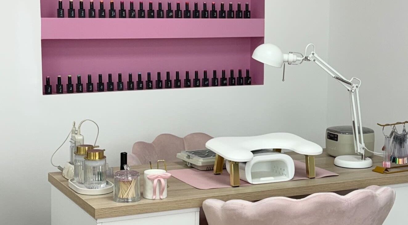 Stylish nail station at Anna Rae Beauty, Paisley, Scotland, GB, showcasing manicure tools and polish display.
