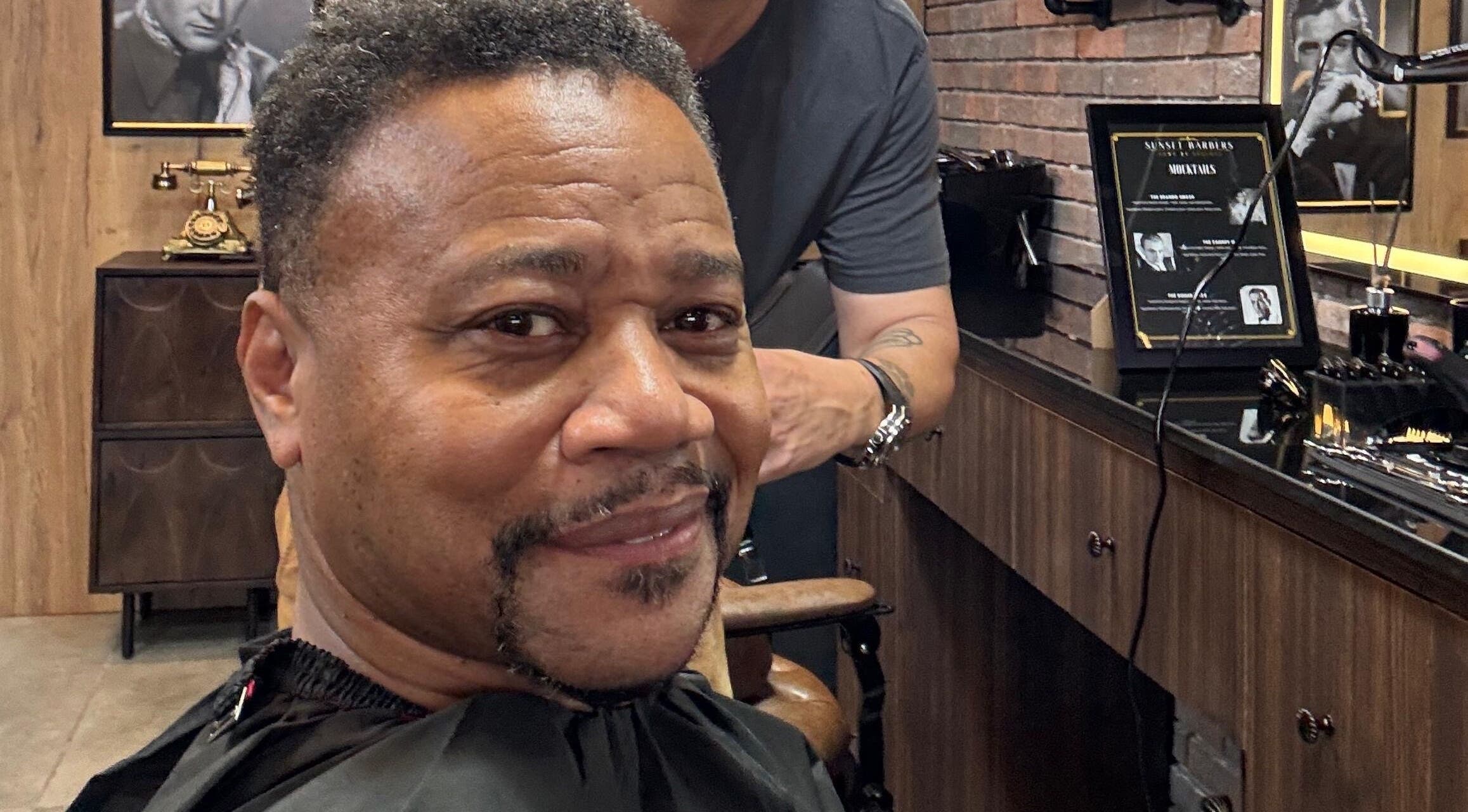 Customer enjoying a haircut at Sunset Barbers in Dubai, Dubai, AE. Cozy and welcoming interior.