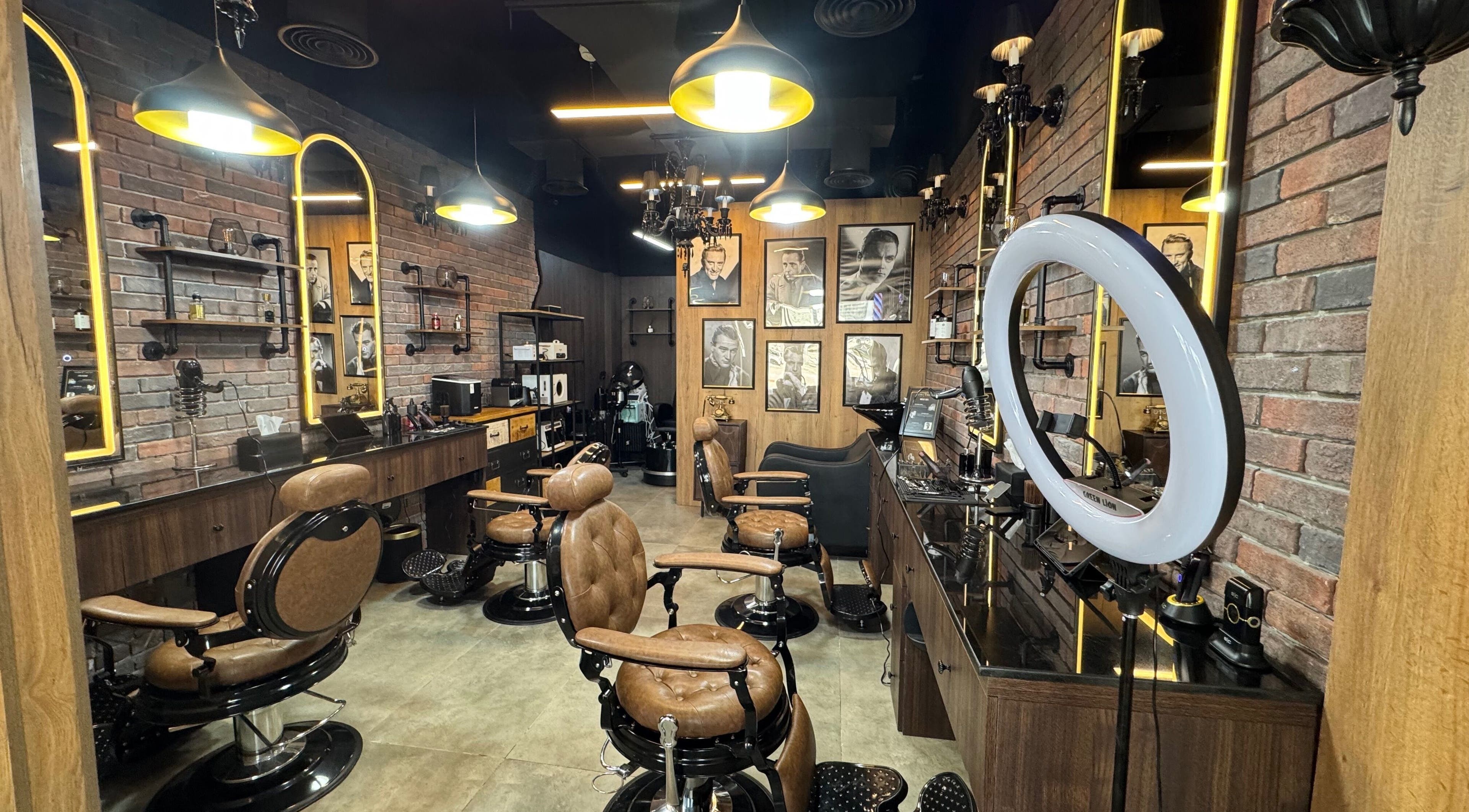 Stylish interior of Sunset Barbers featuring leather chairs in Dubai, Dubai, AE.