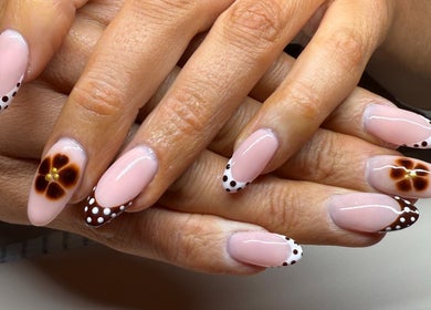 Artistic nail design with floral and polka dot patterns at Gels By Bethan, Marske-by-the-sea, England, GB.
