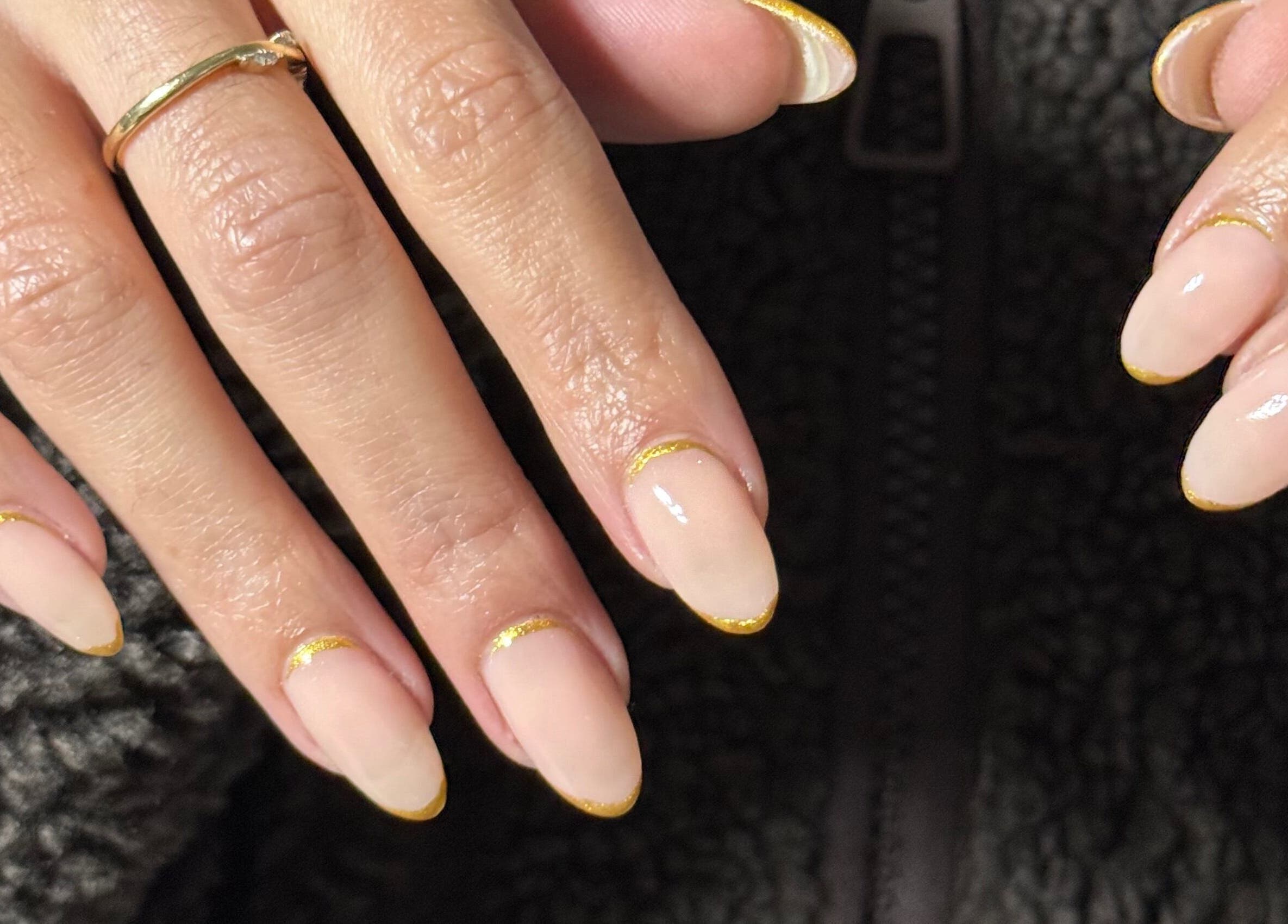 Elegant nail polish with gold accents at Gels By Bethan in Marske-by-the-sea, England, GB.