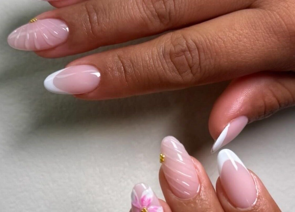 Manicura creativa en AMAR Nails Studio de Miami, Florida, US, destacando elegantes diseños en rosa y blanco.
