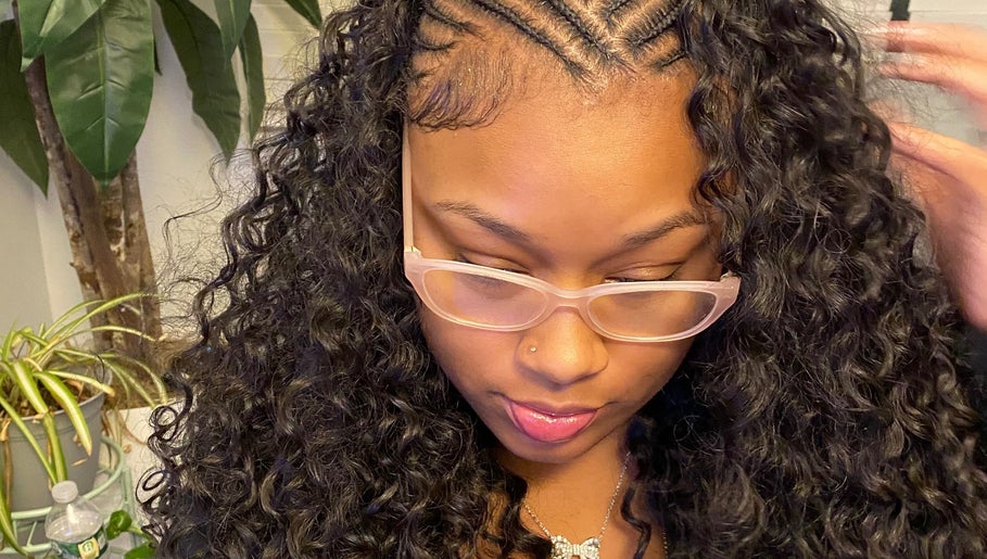 Intricate braided hairstyle with curls at DoneByDeonne in Bronx, NY, US, showcasing beauty and style.