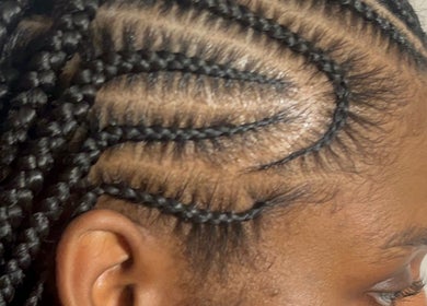 Close-up of intricate braided hairstyle by DoneByDeonne in Bronx, NY, US.