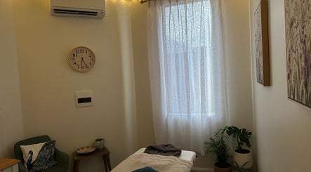 Relaxing therapy room at Gaia Holistic Therapies, Wagga Wagga, New South Wales, AU with soft lighting and cozy decor.