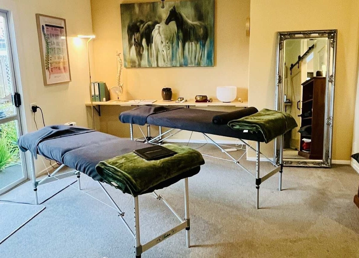 Massage room at Omega Wellness, Waimate North, Northland Region, NZ with twin treatment tables and serene decor.