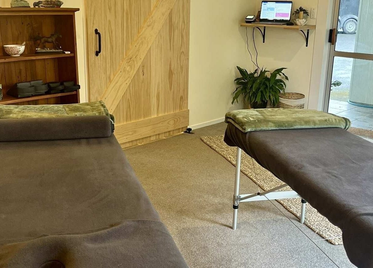 Relaxing therapy room at Omega Wellness, Waimate North, Northland Region, NZ with cozy massage tables.