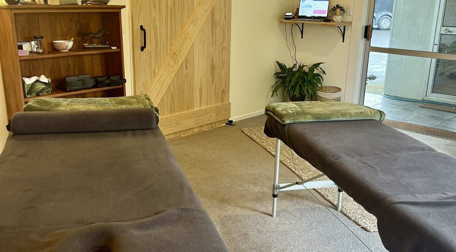 Relaxing therapy room at Omega Wellness, Waimate North, Northland Region, NZ with cozy massage tables.