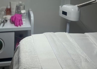 Clean beauty spa room at GSkinStudio, Dieppe, New Brunswick, CA with tools and pink gloves on a counter.