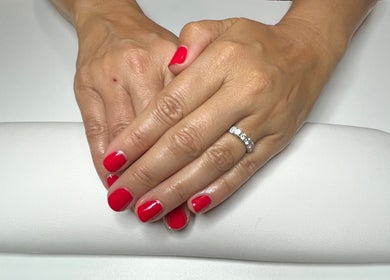 Red manicured hands at GSkinStudio in Dieppe, New Brunswick, CA.