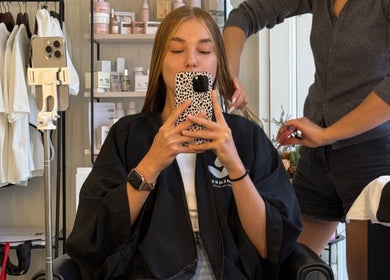 A stylist working on a client's hair at Kora Beauty Space, Cascais, Lisboa, PT.