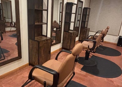 Elegant salon interior at Nova beauty boutique by Carla Torres, Santa Fe, New Mexico, US. Modern styling chairs and mirrors.