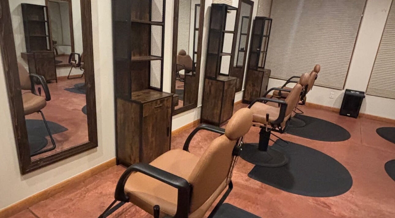 Modern salon interior at Nova Beauty Boutique By Carla Torres in Santa Fe, New Mexico, US with stylish chairs and mirrors.