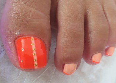 Decoración de uñas con esmalte naranja en Erika nails, Newry, GB.