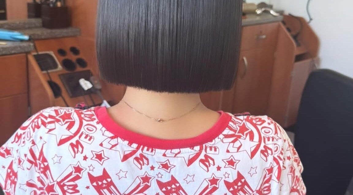 Sleek bob hairstyle at Jing Zhou salon, San Mateo, California, US. Modern salon chair and styling tools visible.