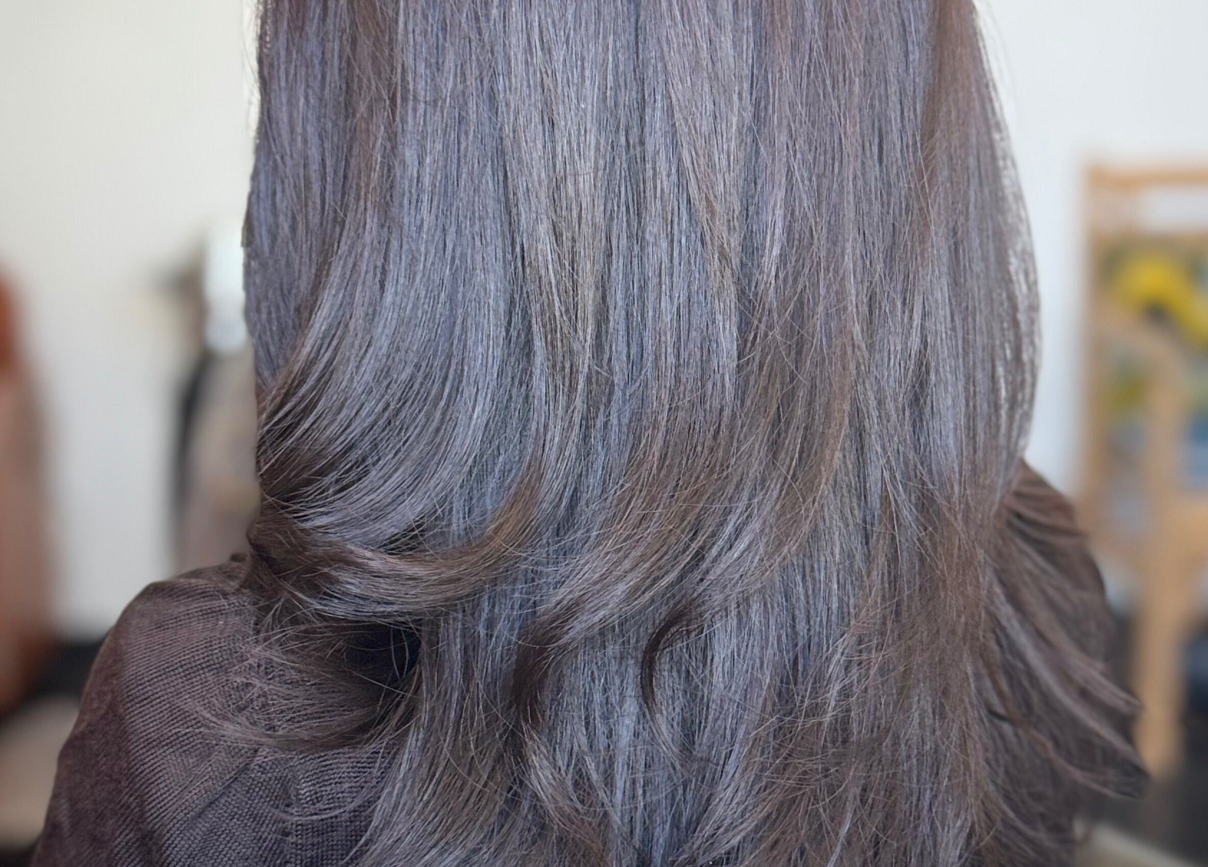 Smooth, styled hair at Jing Zhou salon, San Mateo, California, US, highlighting professional styling services.