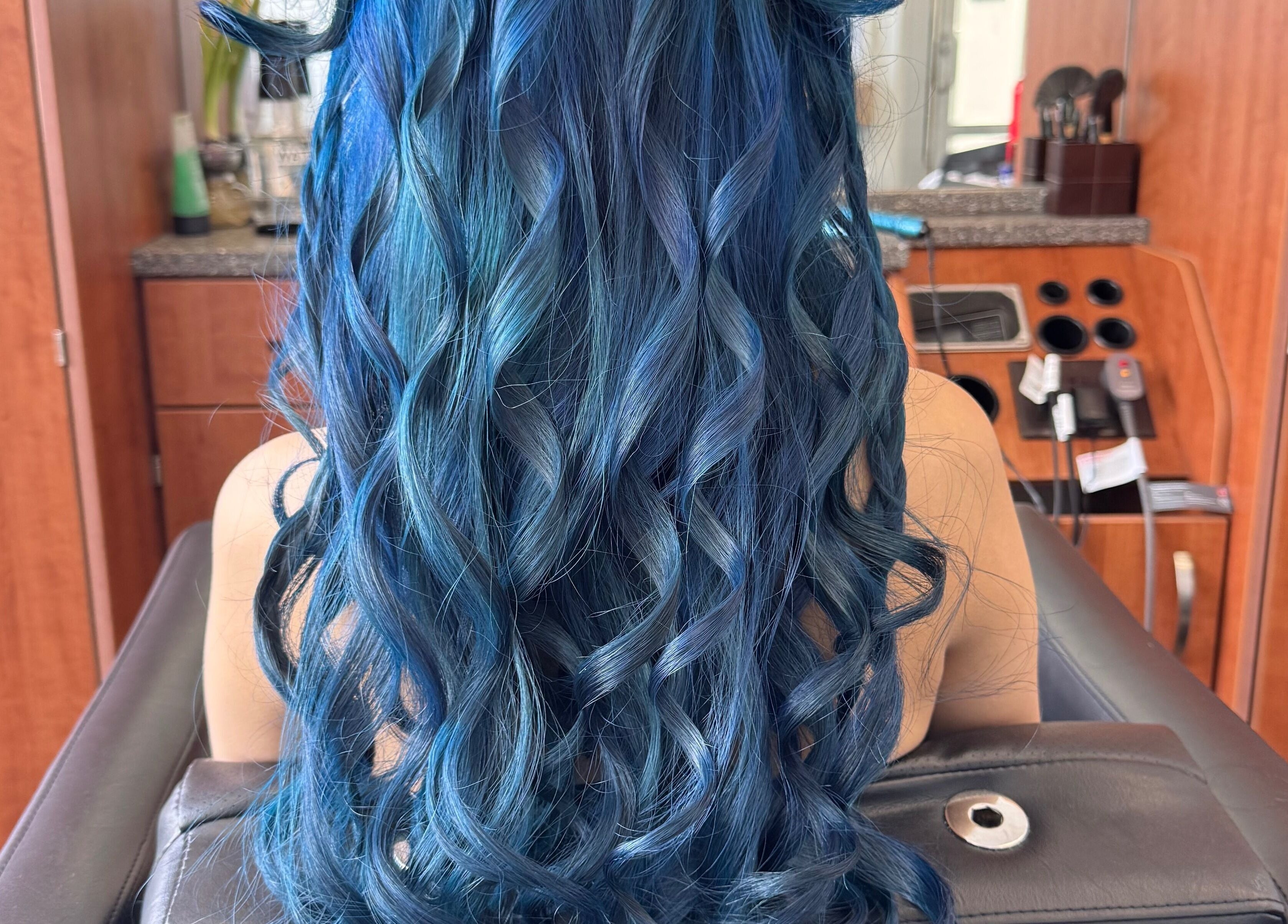 Vibrant blue curls styled at Jing Zhou Salon, San Mateo, California, US. Perfect for bold hair transformations.
