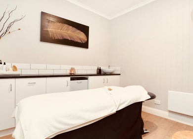 Relaxing spa treatment room at Port Fairy Day Spa, Port Fairy, Victoria, AU, featuring a cozy massage table.