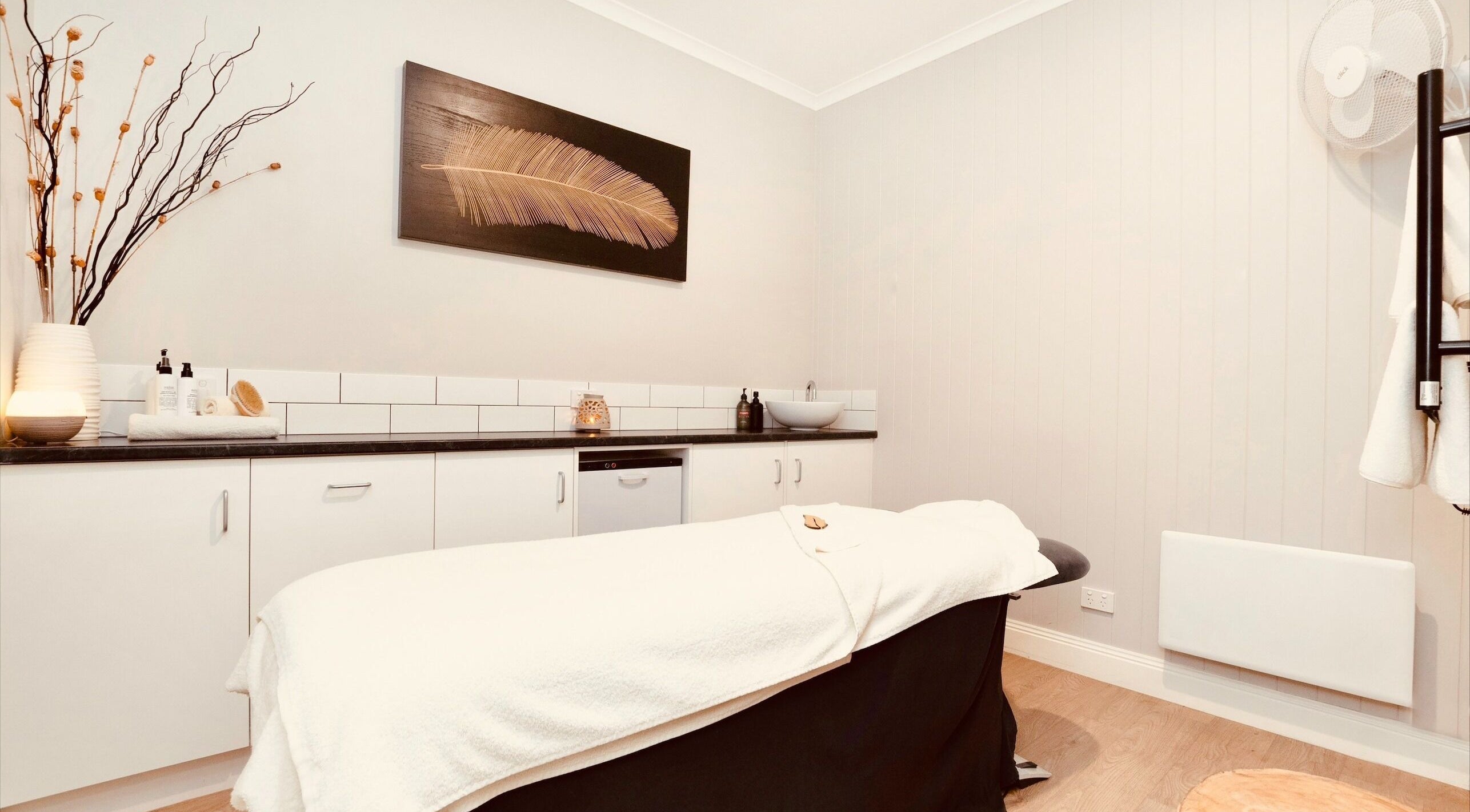 Relaxing spa treatment room at Port Fairy Day Spa, Port Fairy, Victoria, AU, featuring a cozy massage table.